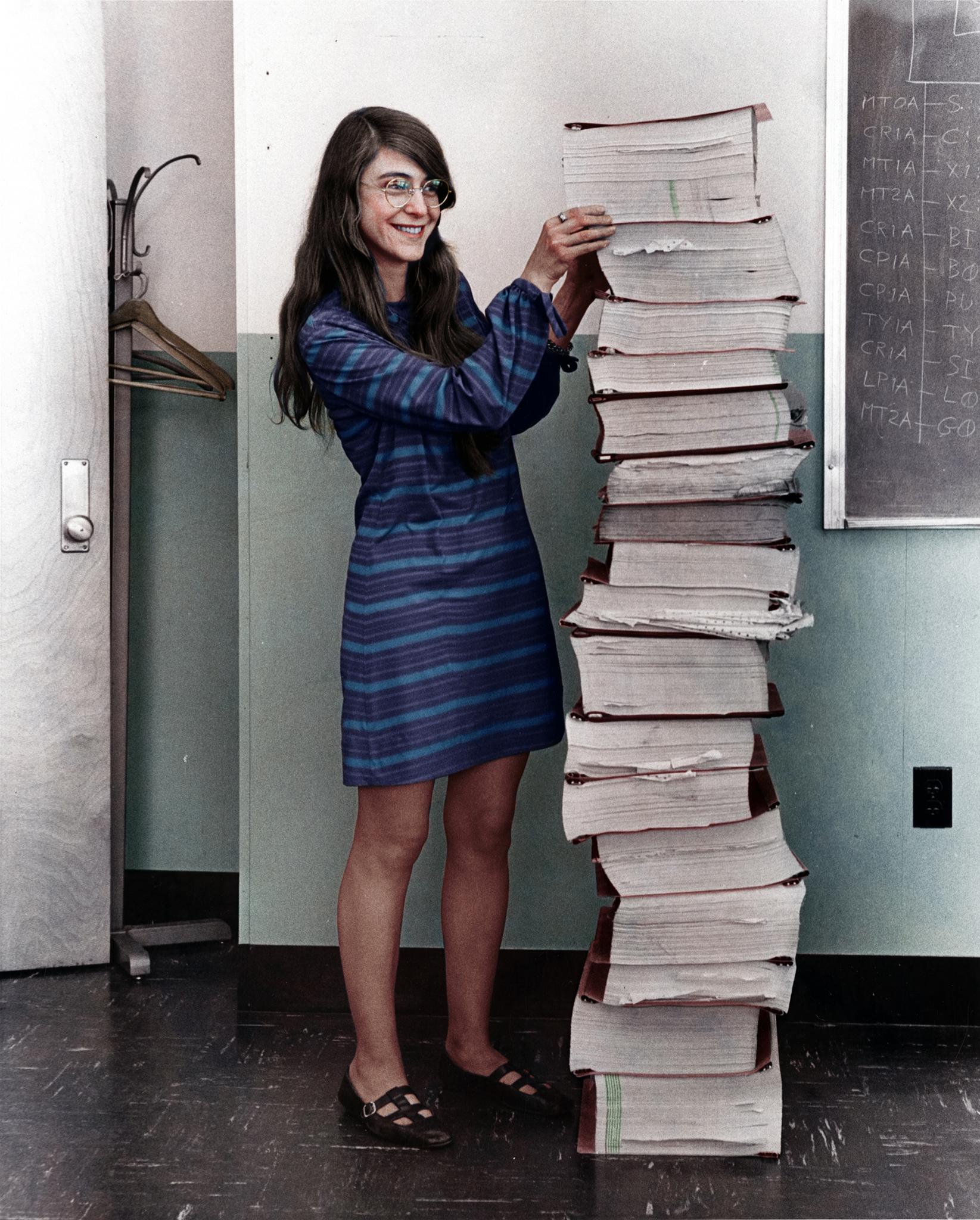 Margaret Hamilton with the stack of code that got humanity to the Moon.